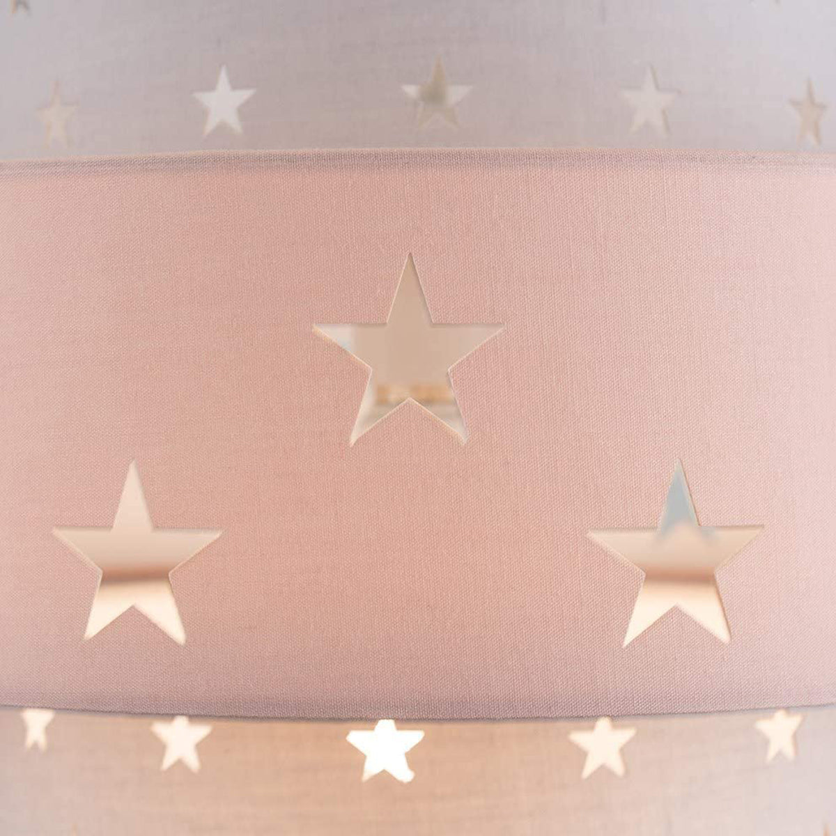 Our grey and pink two tiered star shade features a mixture of large and small sweet stars cut out across a grey and pink background. When your lamp is turned on it will shine out through these cut-outs, mimicking a beautiful night sky. This lampshade is made with soft-touch fabric for a little bit of luxury.