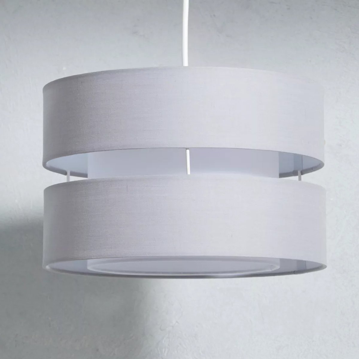 Our Gayle two tiered luxury fabric double layered shade is contemporary in its appearance and we have designed the shade to suit a range of interiors. Easy to fit simply attached to an existing pendant flitting.  It is crafted from high quality fabric material in two layers and complimented with a white inner which looks beautiful when light shines through. The shade has been made to fit both a ceiling light or lamp base.